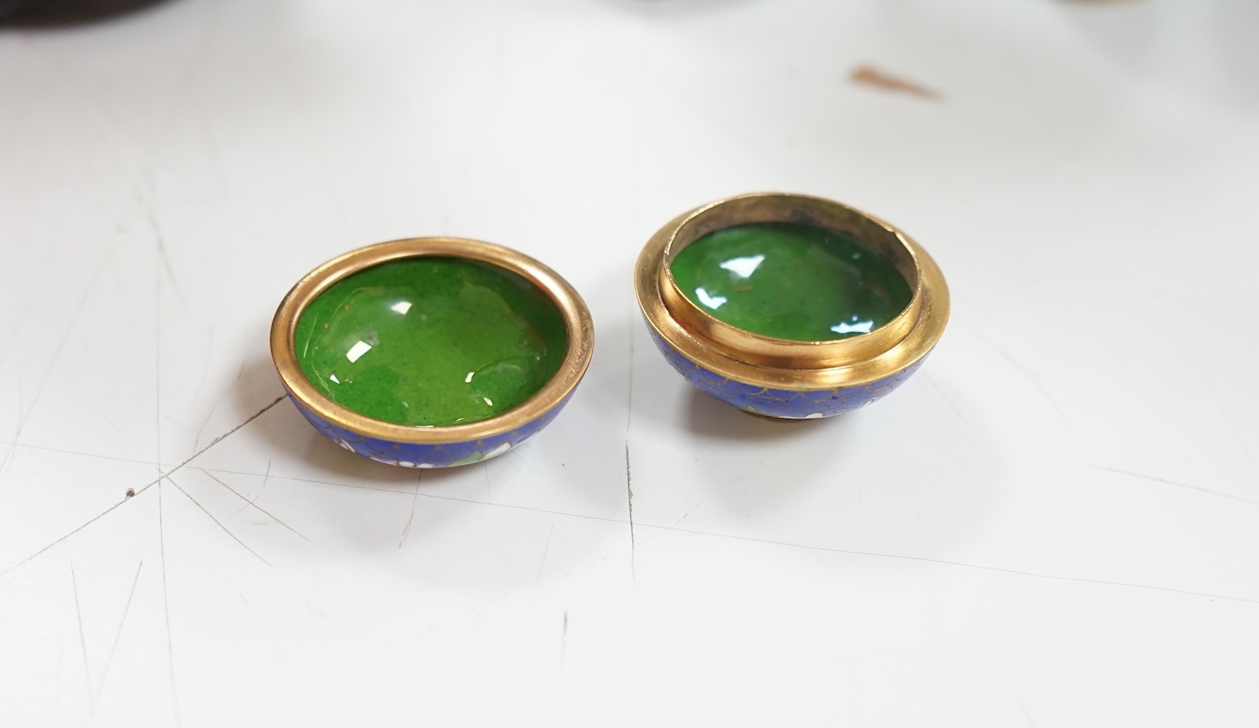 A collection of Chinese cloisonné enamel wares, with mixed coloured backgrounds, all with floral designs, some with stands, plate 21cm diameter. Condition - good